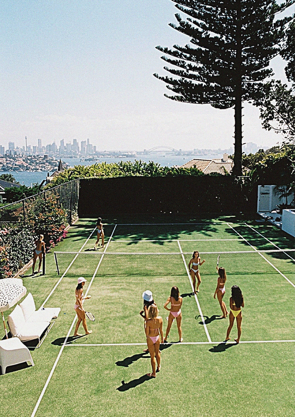 This view shows the poster of girls in bikinis playing tennis with sydney in the background. old money aesthetic poster.